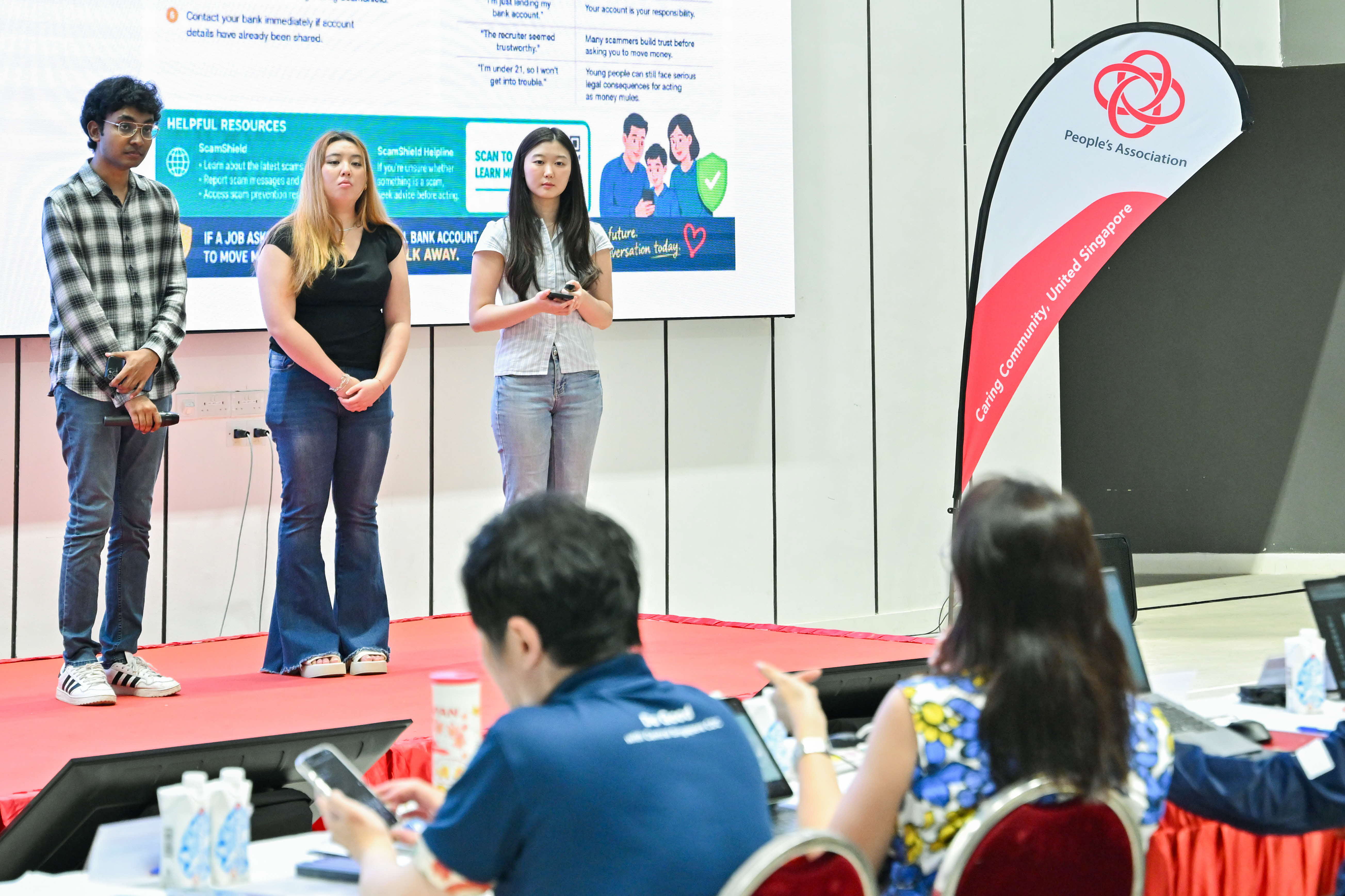 Students listening to the feedback given by a member of the panel